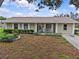Charming single-story home with a well-maintained lawn and cozy front porch with rocking chairs at 4003 Prairie Bend Ln, Lakeland, FL 33812