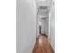Neutral hallway featuring wood floors and white walls, leading to other rooms in the home at 4003 Prairie Bend Ln, Lakeland, FL 33812