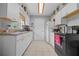 A bright kitchen with white cabinets, neutral countertops, and tile floors at 4003 Prairie Bend Ln, Lakeland, FL 33812