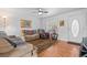 Comfortable living room with wood floors, a ceiling fan, and an inviting atmosphere for relaxation at 4003 Prairie Bend Ln, Lakeland, FL 33812