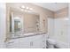 Bathroom with granite vanity, a shower, and updated cabinets at 647 San Pedro Dr, Lady Lake, FL 32159