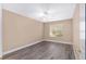 Bedroom with modern gray flooring, white trim, and a window providing natural light at 647 San Pedro Dr, Lady Lake, FL 32159