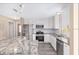 Bright, renovated kitchen with granite countertops, stainless steel appliances, and ample cabinet space at 647 San Pedro Dr, Lady Lake, FL 32159