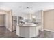 Modern kitchen with stainless steel appliances, granite counters, and a center island, perfect for cooking at 647 San Pedro Dr, Lady Lake, FL 32159