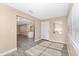 Open concept living room area with modern gray flooring, an island, and a front door at 647 San Pedro Dr, Lady Lake, FL 32159