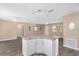 Open concept living room area with modern gray flooring and granite topped island at 647 San Pedro Dr, Lady Lake, FL 32159