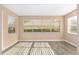 Living room with modern gray flooring, white trim, and large windows for ample light at 647 San Pedro Dr, Lady Lake, FL 32159