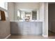 Elegant bathroom featuring dual vanities, a large mirror, and stylish fixtures at 1233 Tidal St, Haines City, FL 33844