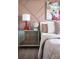 Charming bedroom with a mirrored nightstand and a vibrant art piece at 1233 Tidal St, Haines City, FL 33844