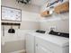 Organized laundry room with modern appliances, shelving for storage, and a convenient layout at 1233 Tidal St, Haines City, FL 33844