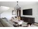 Elegant living room with modern lighting, stylish decor, and a flat-screen TV mounted on a patterned wall at 1233 Tidal St, Haines City, FL 33844