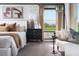Serene main bedroom featuring a plush bed, modern furniture, and a calming view at 1233 Tidal St, Haines City, FL 33844