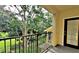 Enjoy lush views from this private balcony with black metal railing and a doorway that provides seamless indoor-outdoor living at 2572 Robert Trent Jones Dr # 1235, Orlando, FL 32835