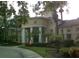 The community clubhouse stands elegantly with classic columns and meticulous landscaping, reflecting sophistication and charm at 2572 Robert Trent Jones Dr # 1235, Orlando, FL 32835