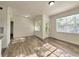 Sunlit living room with wood floors and a patio door, offering access to outdoor space at 2572 Robert Trent Jones Dr # 1235, Orlando, FL 32835