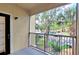Relaxing balcony view with trees and parking at 2586 Robert Trent Jones Dr # 1124, Orlando, FL 32835