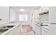 Bright kitchen featuring white appliances, light countertops, and an open view to the dining area at 2586 Robert Trent Jones Dr # 1124, Orlando, FL 32835