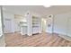 Open-concept living space with white walls, wood flooring, and a built-in serving area at 2586 Robert Trent Jones Dr # 1124, Orlando, FL 32835