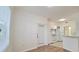 Well-lit living area leading to the kitchen with white appliances and a sliding door with blinds at 2586 Robert Trent Jones Dr # 1124, Orlando, FL 32835