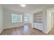 Bright living area with wood floors, large windows offering natural light, and a built-in serving area at 2586 Robert Trent Jones Dr # 1124, Orlando, FL 32835