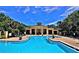 Sparkling community pool with ample lounge seating at 2586 Robert Trent Jones Dr # 1124, Orlando, FL 32835