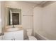 Bathroom featuring a white vanity, toilet, and tub with tile surround at 4106 Gerbera Daisy Ave, Lake Hamilton, FL 33851