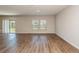 Bright living space featuring wood floors, natural light, and sliding door leading to backyard at 4106 Gerbera Daisy Ave, Lake Hamilton, FL 33851