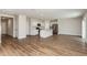 Spacious living area featuring wood floors that connect seamlessly to the kitchen and dining at 4106 Gerbera Daisy Ave, Lake Hamilton, FL 33851