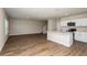Bright living space showcasing an open floor plan with hardwood floors and access to kitchen at 4106 Gerbera Daisy Ave, Lake Hamilton, FL 33851
