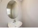 Small powder room featuring a pedestal sink and an oval mirror and a window at 4106 Gerbera Daisy Ave, Lake Hamilton, FL 33851
