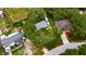 Aerial view of a single Gathering home surrounded by mature trees on a generous lot near neighborhood homes at 4854 Myrtle View N Dr, Mulberry, FL 33860