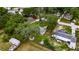 Aerial view of home with mature trees, utility shed, fenced in yard and landscaping at 4854 Myrtle View N Dr, Mulberry, FL 33860