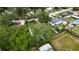 Aerial view of a home surrounded by lush trees in a quiet neighborhood at 4854 Myrtle View N Dr, Mulberry, FL 33860
