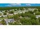 An aerial view shows the house surrounded by large trees in a residential neighborhood at 4854 Myrtle View N Dr, Mulberry, FL 33860
