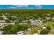 Aerial view of neighborhood landscape, home and trees marked with a red location pin at 4854 Myrtle View N Dr, Mulberry, FL 33860