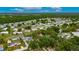 Aerial view of a neighborhood with single Gathering homes surrounded by mature trees and greenery at 4854 Myrtle View N Dr, Mulberry, FL 33860