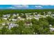 A neighborhood of single Gathering homes is shown from an aerial view surrounded by trees at 4854 Myrtle View N Dr, Mulberry, FL 33860