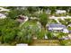 Aerial view of single story home with boat and landscaping in a tree covered yard at 4854 Myrtle View N Dr, Mulberry, FL 33860