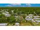 Aerial view of neighborhood with mature trees, landscaping and the property marked with red at 4854 Myrtle View N Dr, Mulberry, FL 33860