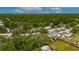 Aerial view of neighborhood landscape, home and trees with red marker pin at 4854 Myrtle View N Dr, Mulberry, FL 33860