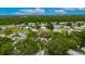 An aerial view of single Gathering homes in a wooded residential neighborhood on a sunny day at 4854 Myrtle View N Dr, Mulberry, FL 33860