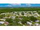 Aerial view of a neighborhood featuring single Gathering homes surrounded by mature trees and lush greenery at 4854 Myrtle View N Dr, Mulberry, FL 33860