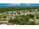 Aerial view of a neighborhood featuring single Gathering homes surrounded by mature trees and lush greenery at 4854 Myrtle View N Dr, Mulberry, FL 33860