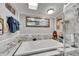 Bright bathroom featuring a luxurious tub and glass shower enclosure with eye-catching tile at 4854 Myrtle View N Dr, Mulberry, FL 33860