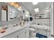 Bright bathroom featuring a skylight, marble tile, and tub and shower combination at 4854 Myrtle View N Dr, Mulberry, FL 33860