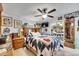 Inviting bedroom with quilt bed, ceiling fan, and wooden dresser with mirror sliding closet doors at 4854 Myrtle View N Dr, Mulberry, FL 33860