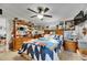 Well-decorated bedroom featuring a quilt bed, ceiling fan, and ample wooden dresser storage space at 4854 Myrtle View N Dr, Mulberry, FL 33860