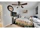 Bedroom featuring a ceiling fan, TV, and bed with decorative pillows and comfortable decor at 4854 Myrtle View N Dr, Mulberry, FL 33860