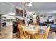 Dining area with wood flooring and seamless flow into the living room and kitchen at 4854 Myrtle View N Dr, Mulberry, FL 33860
