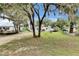 Single-story home with light blue siding, a cozy front porch, and a well-maintained lawn at 4854 Myrtle View N Dr, Mulberry, FL 33860
